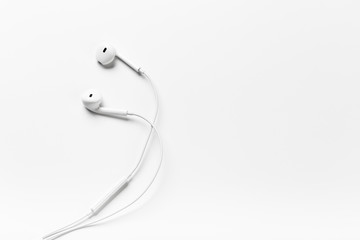 White modern headphones with a headset on a light gray background
