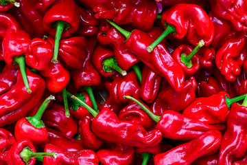 Red bell peppers in a box at a farmers market, pepper pattern