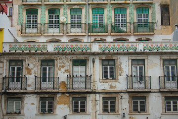 Fototapeta na wymiar Facade of a worn down old buildings in Lisbon Portugal