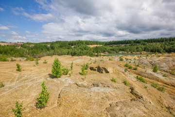 Fototapeta na wymiar Dull landscape on abandoned mining site with surface dump