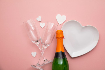Romantic meal background. Heart shaped plate with champagne and glasses