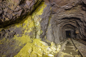 Old copper mine underground tunnel with collapsed wall