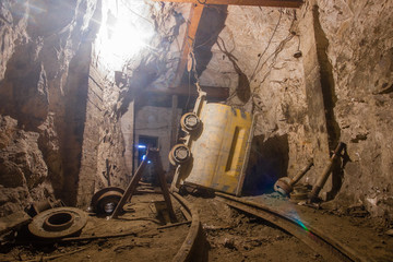 Gold mine underground tunnel with mining ore carts wagons