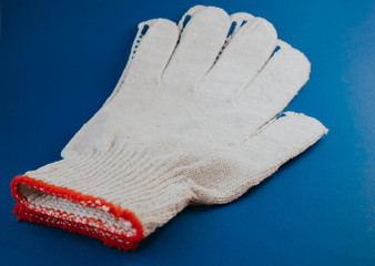 white construction gloves on a blue background.
