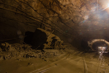 Gold mine underground tunnel with mining ore carts wagons
