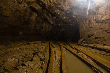 Gold mine underground tunnel with rails