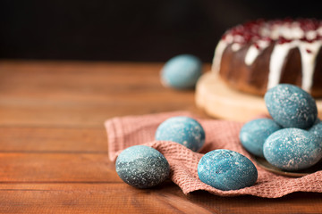 Fototapeta na wymiar Chocolate cake and easter eggs are painted in cosmic blue. Easter menu.