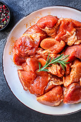 raw meat pork or beef in a plate on the table (preparing healthy food, marinade and spices paprika) menu concept background. top view. copy space