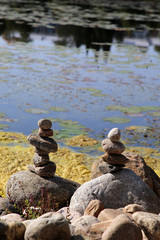 Stacks of natural rocks by the beach of lake Valkeinen in Kuopio, Finland. Beautiful inspiring zen like view to a garden with rocks by the water. Relaxing, simple view, perfectly peaceful and idyllic.