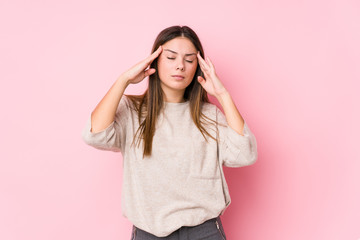 Young caucasian woman posing isolated touching temples and having headache.