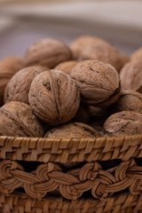 Walnut. Small wicker basket filled with walnuts on a white background