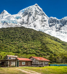 A farm with snow big mountain as background.