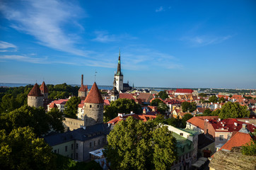 Aerial cityscape with Medieval Old Town, St. Olaf Baptist Church and Tallinn City Wall in the sunny day, Tallinn, Estonia