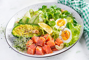 Ketogenic diet breakfast. Salt salmon salad with greens, cucumbers, eggs and avocado. Keto/paleo lunch.