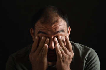 latin american man tired and fatigued