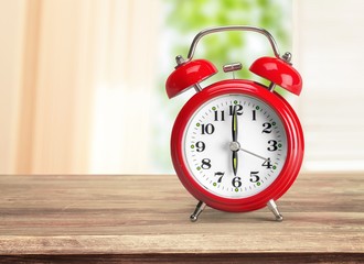 Retro classic alarm clock on wooden desk