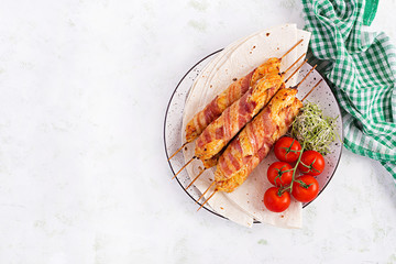 Minced Lula kebab grilled turkey (chicken) with pumpkin wrapped in bacon on plate. Top view, overhead