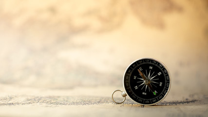 compass on the old map. - travel and transportation concept.