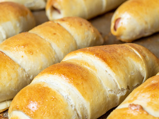 Ready-made juicy sausage in the dough. Close-up of a flour product