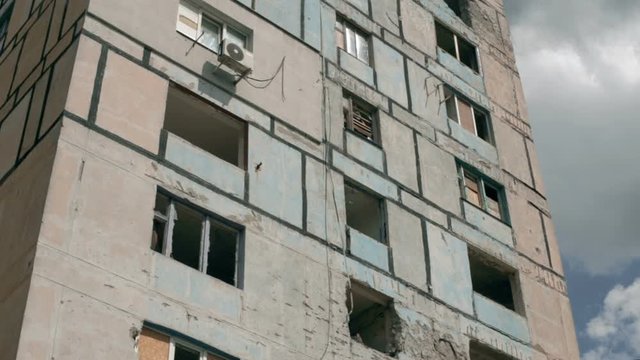Residential building, shot by Russian tanks. Tilt.