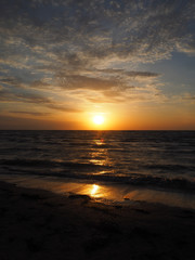 Golden sunrise on a deserted beach vertically