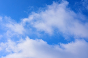 Naklejka na ściany i meble Aerial light white clouds on a blue sky.