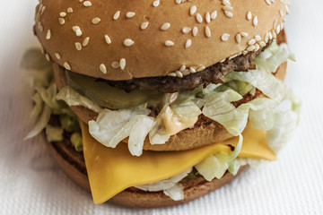 Fresh big burger on a white background. Not healthy food. Fast food concept.