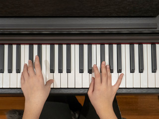 a young lady plays the piano