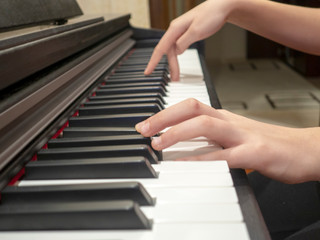 a young lady plays the piano