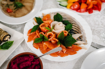 Dish. Red caviar and fish. Tuna. White plate on white table. Food. Fish eggs olives. Holiday food. Wedding day.