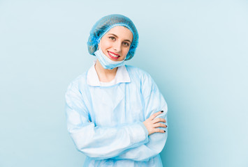 Young surgeon woman isolated laughing and having fun.