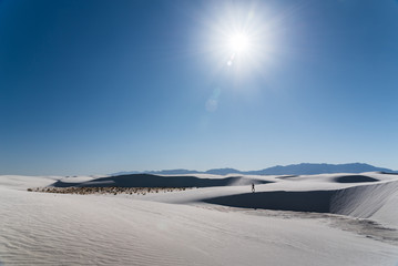 A man walking in the distance at White Sands National Park in Alamogordo, New Mexico. 