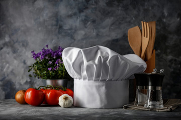 White cook hat on desk and kitchen interior.Free space for your decoration. 