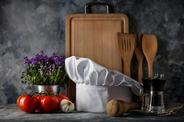 White cook hat on desk and kitchen interior.Free space for your decoration. 