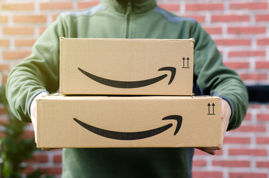 Soest, Germany - January 14, 2019:  Man delivers Amazon Prime package.