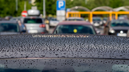 Rain drops on the black car roof
