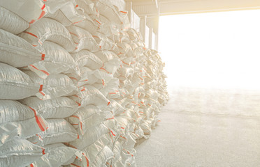 A warehouse in which stacks of bags of goods are stored.