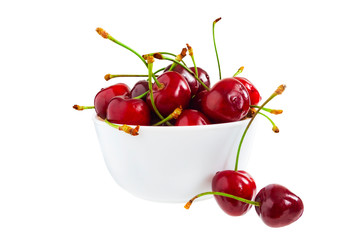 The cherry lies in a plate on a white background.