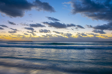 Fototapeta na wymiar Sunrise over the ocean on Cancun beach on Caribbean Sea, Cancun, Quintana Roo QR, Mexico.