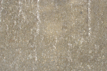 Background of homogeneous gray asphalt with white stripes and spots.