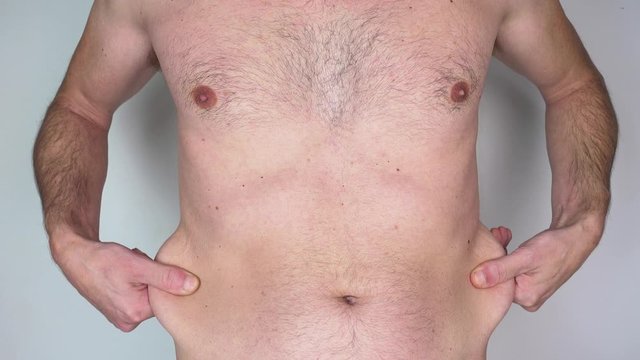 Caucasian shirtless man with stomach fat
