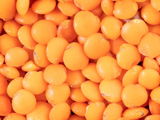 Orange lentil seeds top view, texture.