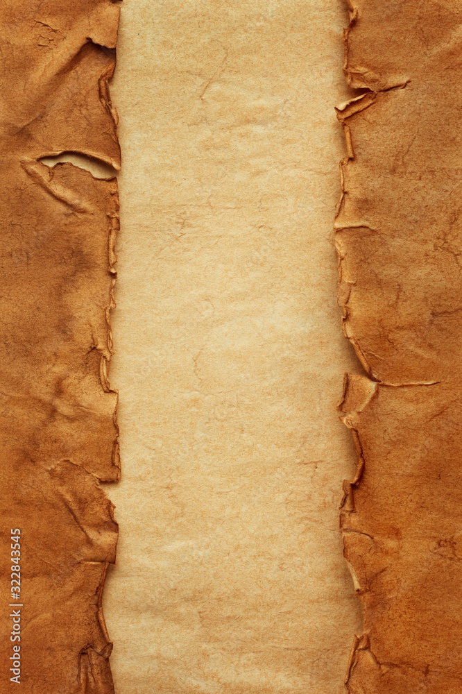 Wall mural vertical oriented old crumpled torn ancient sheets of paper on another vintage sheet of paper with c