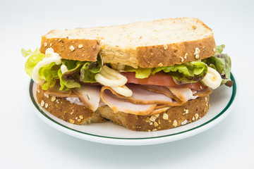 Sandwich of tomato, lettuce and smoked turkey