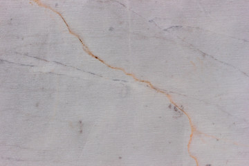Gray scratched marble surface with a crack. Marble texture background.