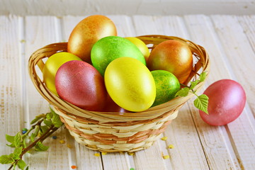 Сelebration of Easter. Brightly colored Easter eggs in a basket.