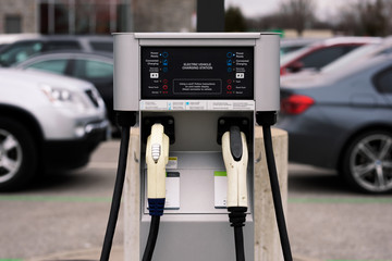 Electric Vehicle Charging Station with Parking Lot View - obrazy, fototapety, plakaty