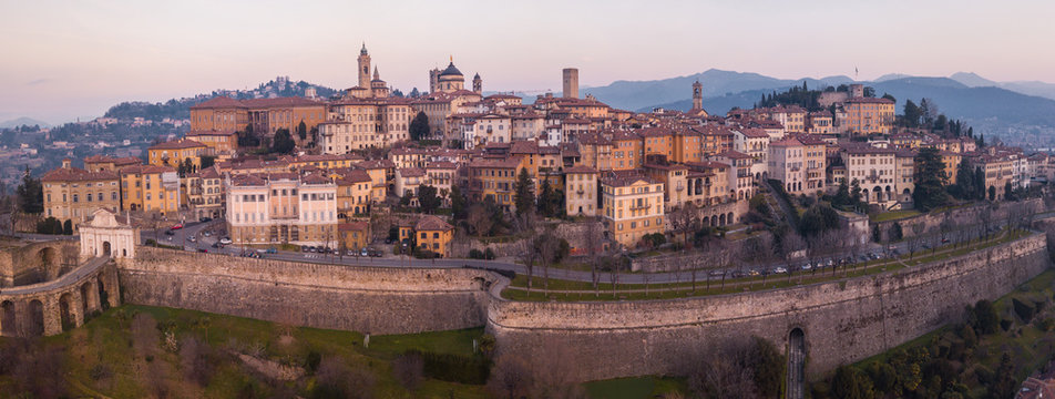 Bergamo, Italy. Drone aerial view of the old town during sunrise. Landscape at the city center, its historical buildings and the Venetian walls a Unesco world heritage