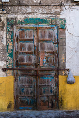 Wooden door of a house with old facade