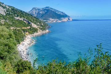 Fototapeta na wymiar AERIAL VIEW OF THE CALA GONONE COAST,BEAUTIFUL LANDSCAPE WITH THE ROCKY MOUNTAINS IN BACKGROUND